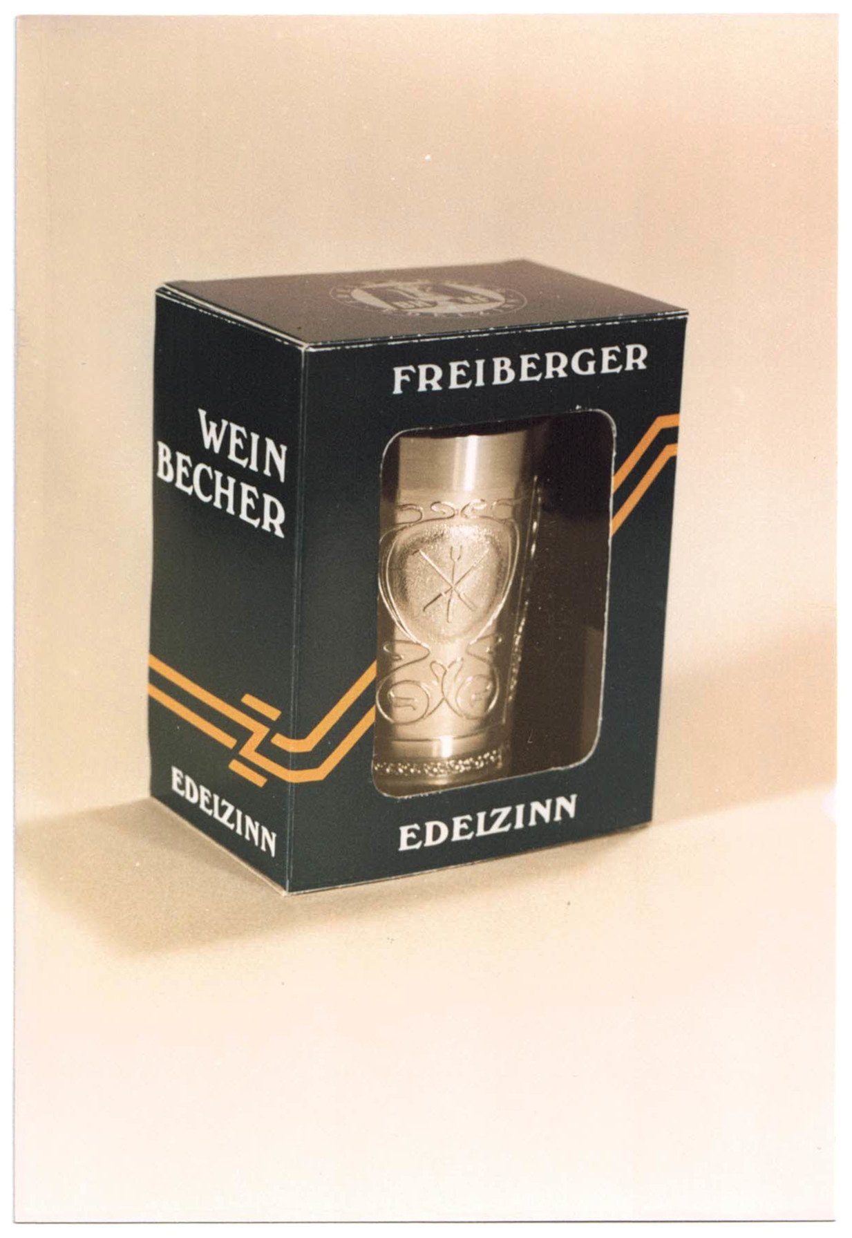 Fotografie eines Weinbechers der Marke "Freiberger Edelzinn" mit Berg- und Hüttenmann und Insignien (Saxonia-Freiberg-Stiftung CC BY-NC-SA)
