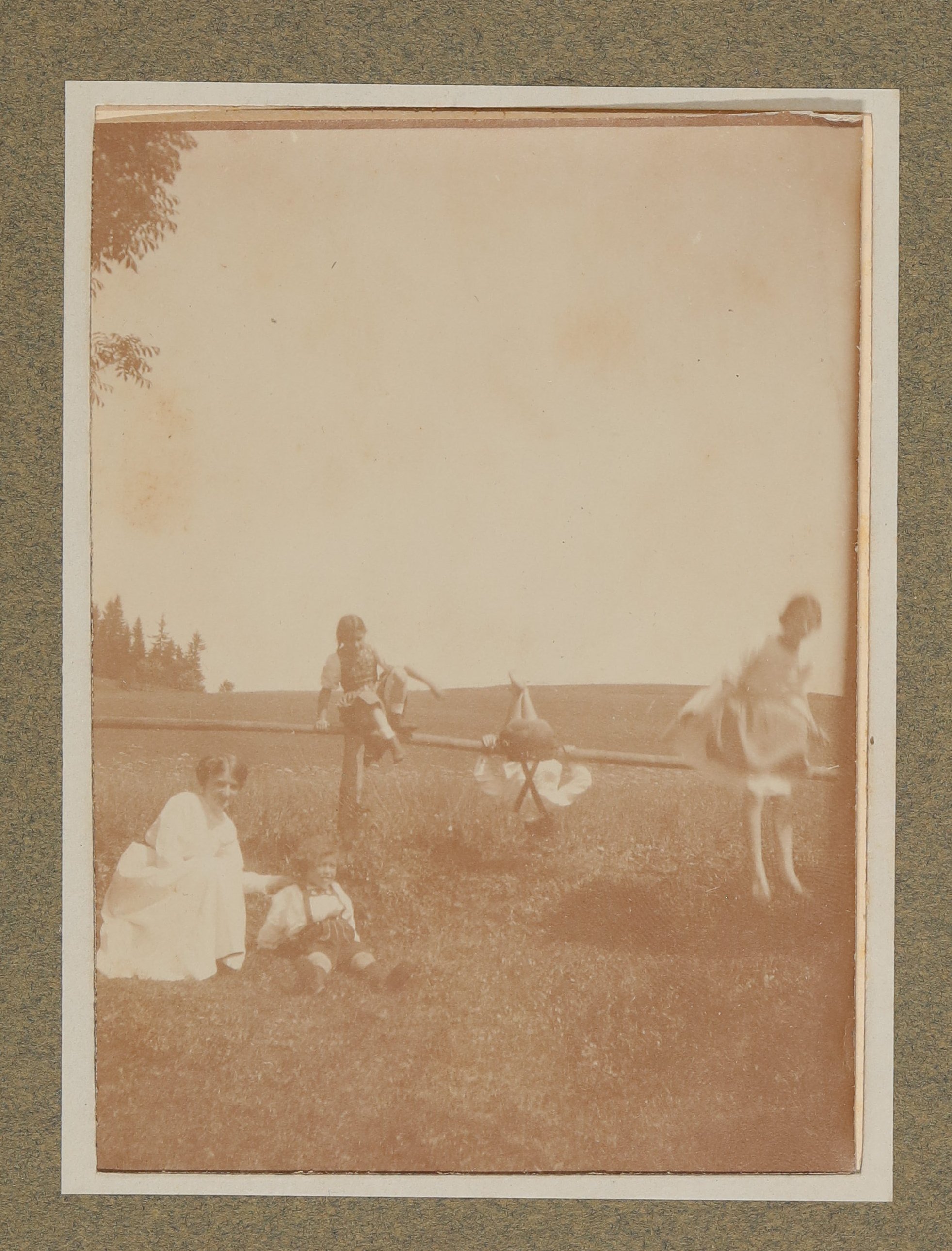 Raimund, Christiane und Franz von Hofmannsthal tollen mit einer Frau und einem Mädchen an einem Holzgeländer in Aussee (Vera Graaf CC BY-NC-SA)