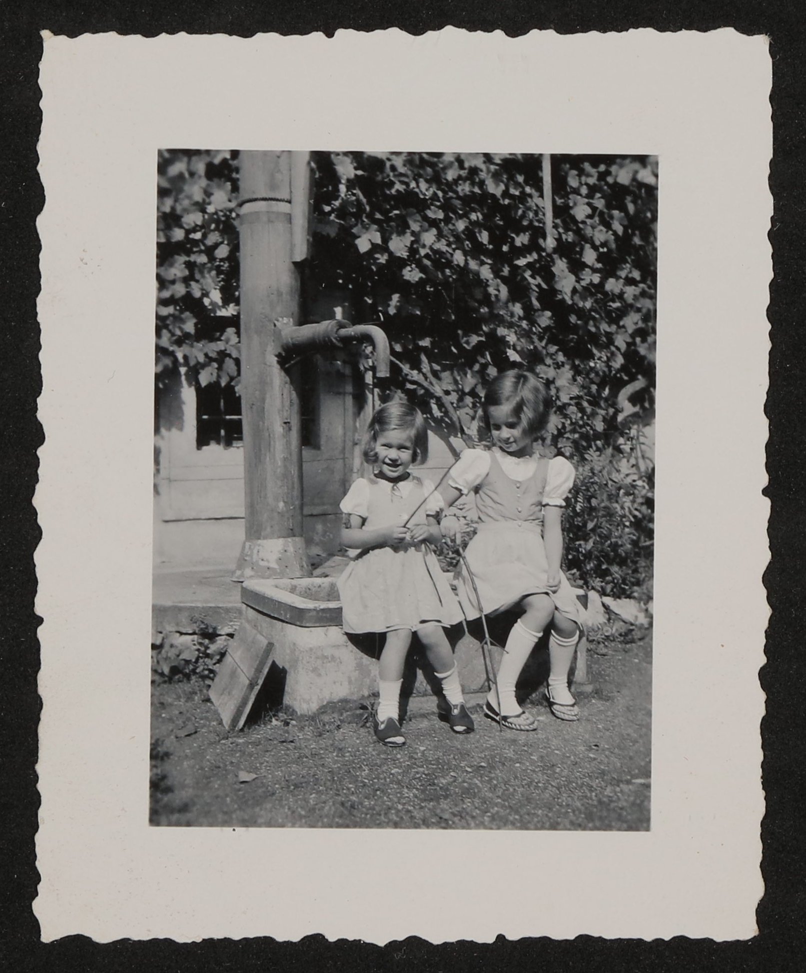 Zwei Mädchen (Christiane und Veronica) sitzen an einem Brunnen (Vera Graaf CC BY-NC-SA)